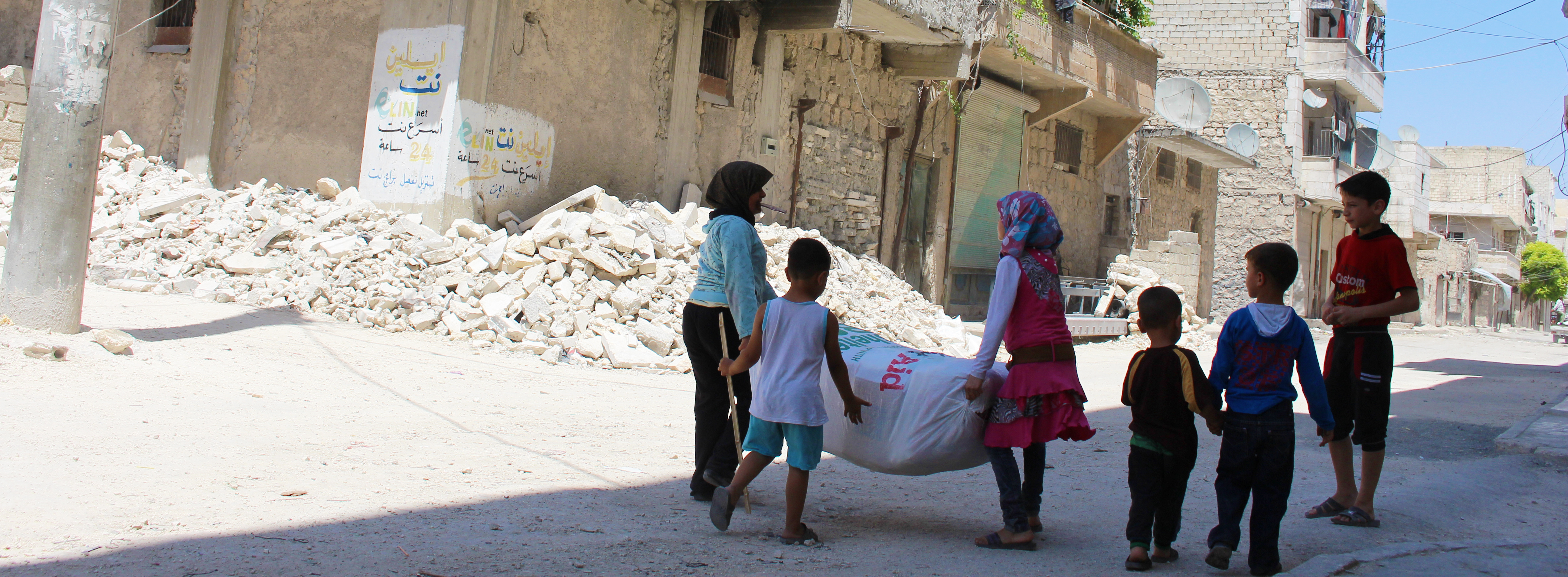 Syrian children receiving aid in Aleppo City