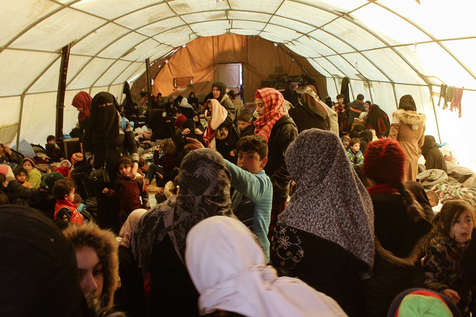 A tent being used as a community centre for families to receive aid